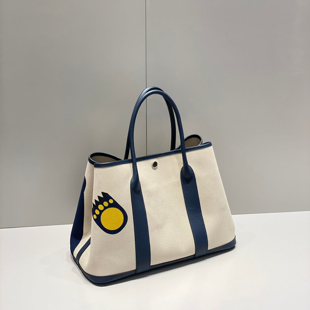 Hermes Garden Party 36 in Navy Cream Toile H Canvas Blue Marine Calfskin Abstract Bear Face Print Bag